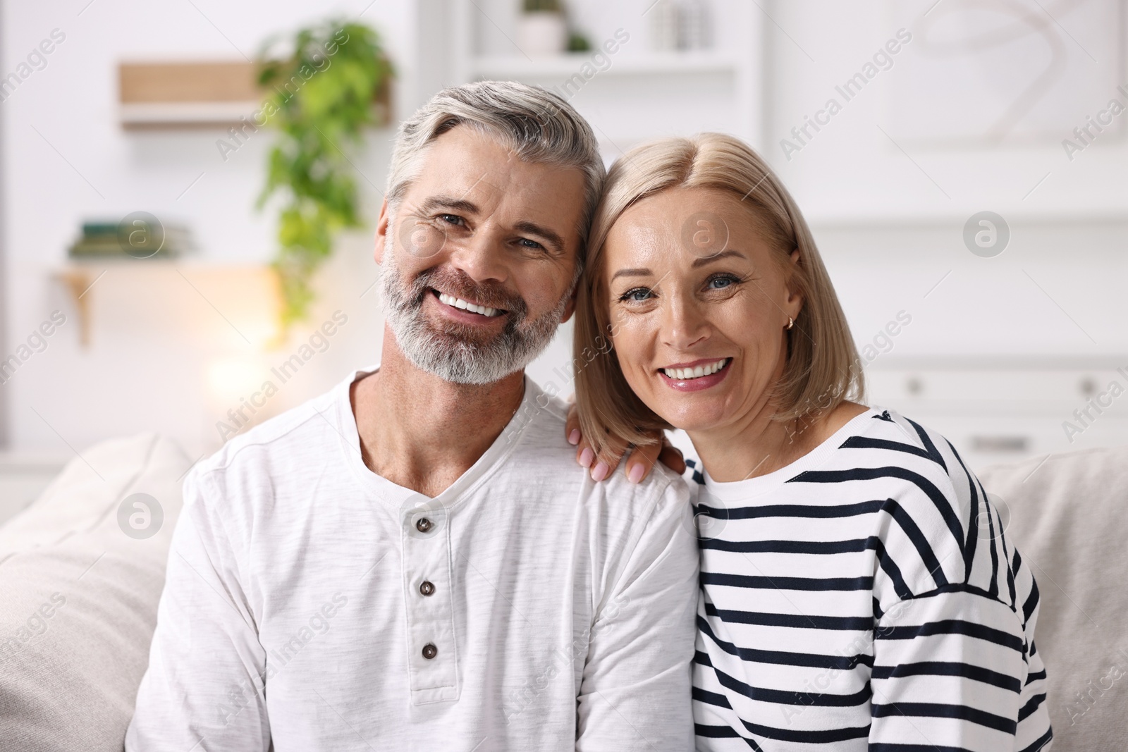 Photo of Portrait of happy middle aged couple indoors