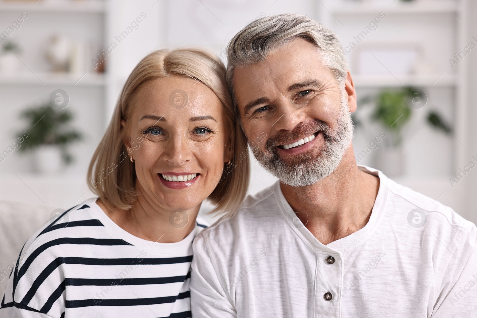 Photo of Portrait of happy middle aged couple indoors