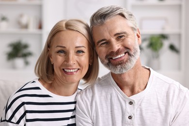 Portrait of happy middle aged couple indoors