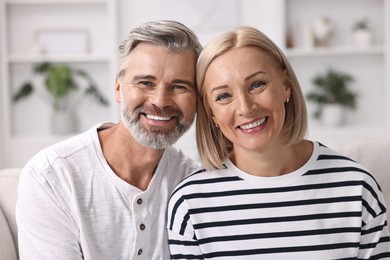 Portrait of happy middle aged couple indoors