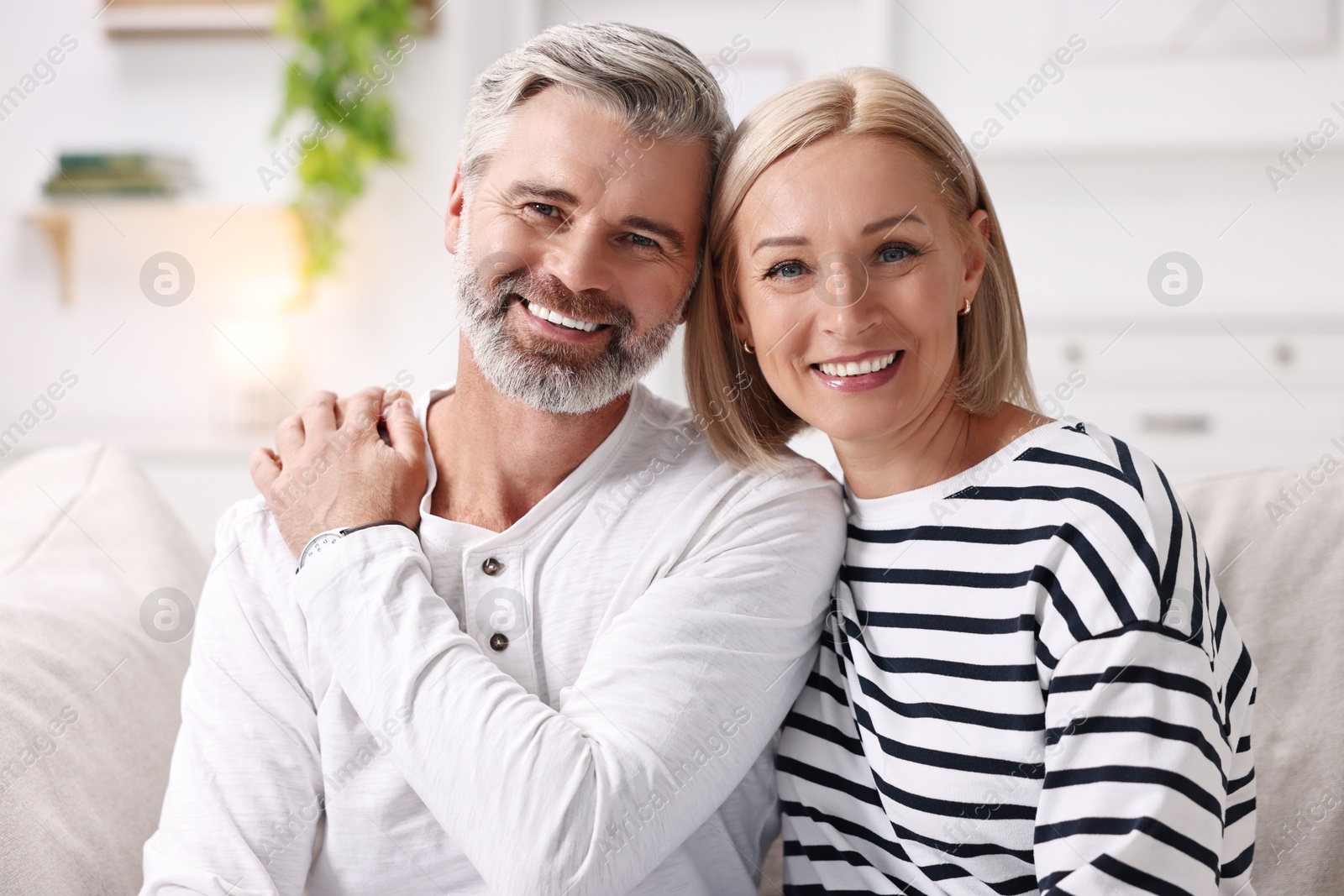 Photo of Portrait of happy middle aged couple indoors