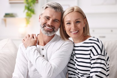 Portrait of happy middle aged couple indoors