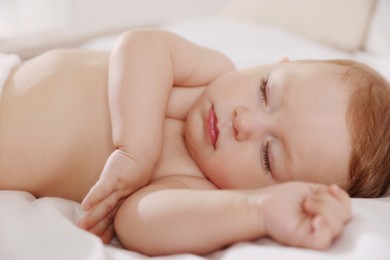 Photo of Cute little baby sleeping on bed at home