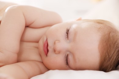 Photo of Cute little baby sleeping on bed at home