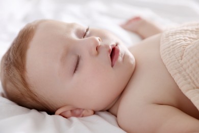 Photo of Cute little baby sleeping on bed at home