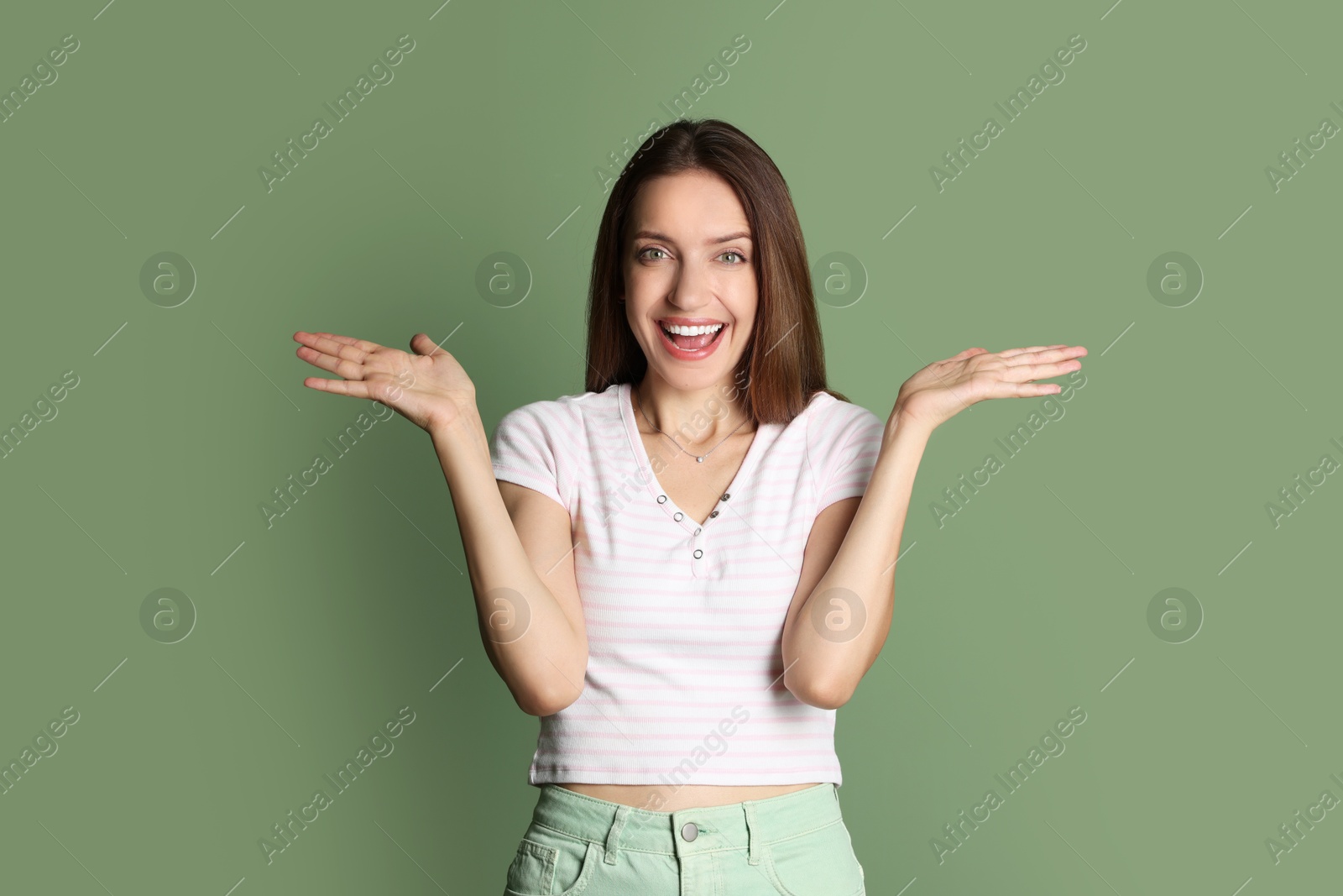 Photo of Portrait of happy winner on green background