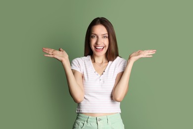 Portrait of happy winner on green background