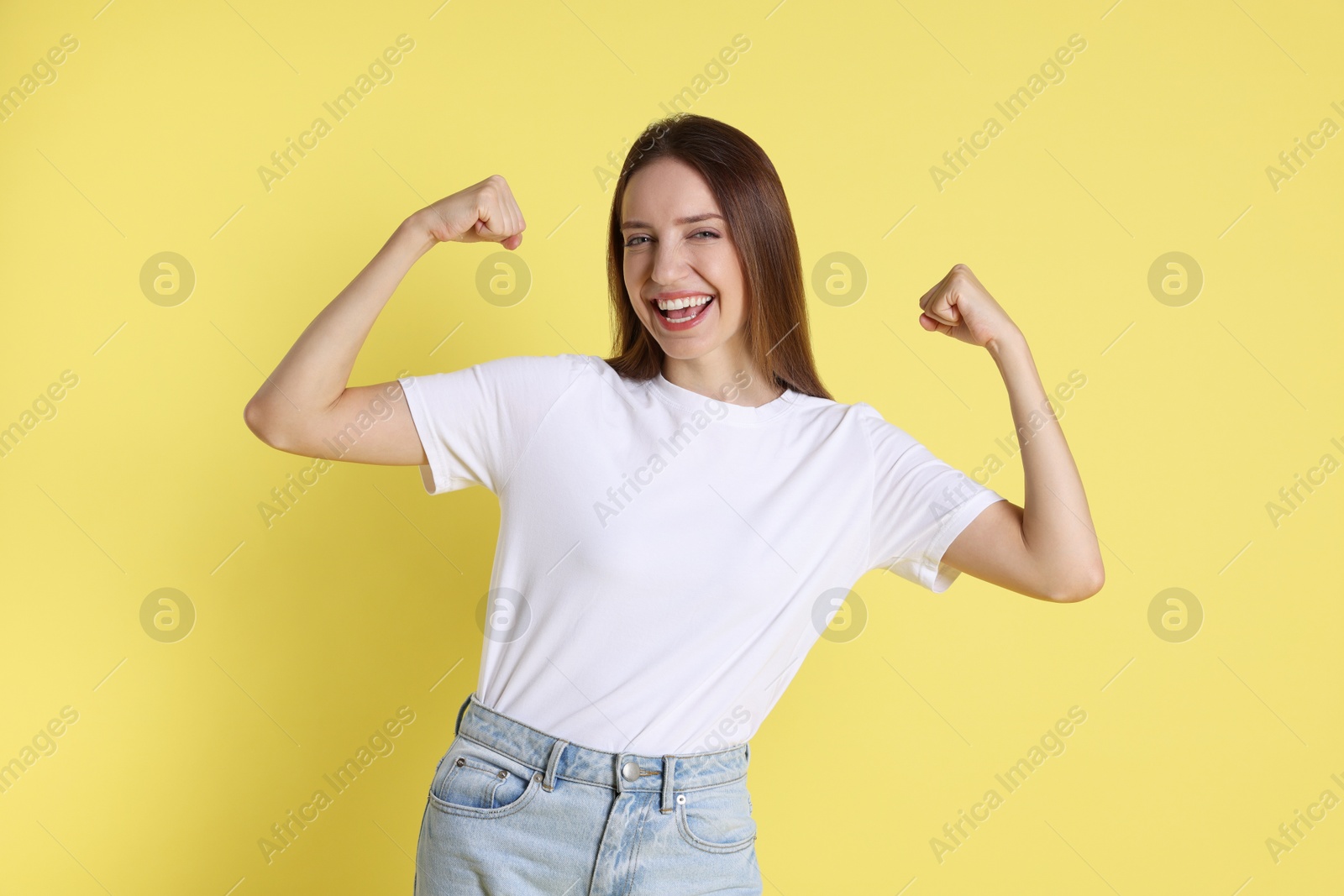 Photo of Portrait of happy winner on yellow background