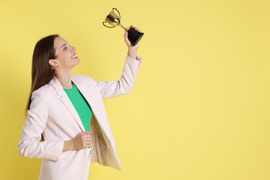 Photo of Happy winner with gold trophy cup on yellow background, space for text