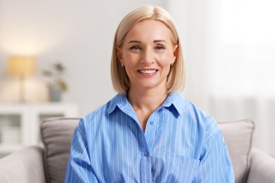 Portrait of smiling middle aged woman at home