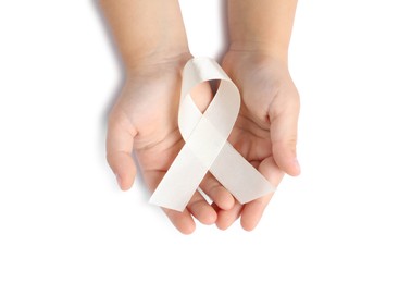 Photo of Child with white ribbon on white background, top view. Bone cancer and lung disease awareness