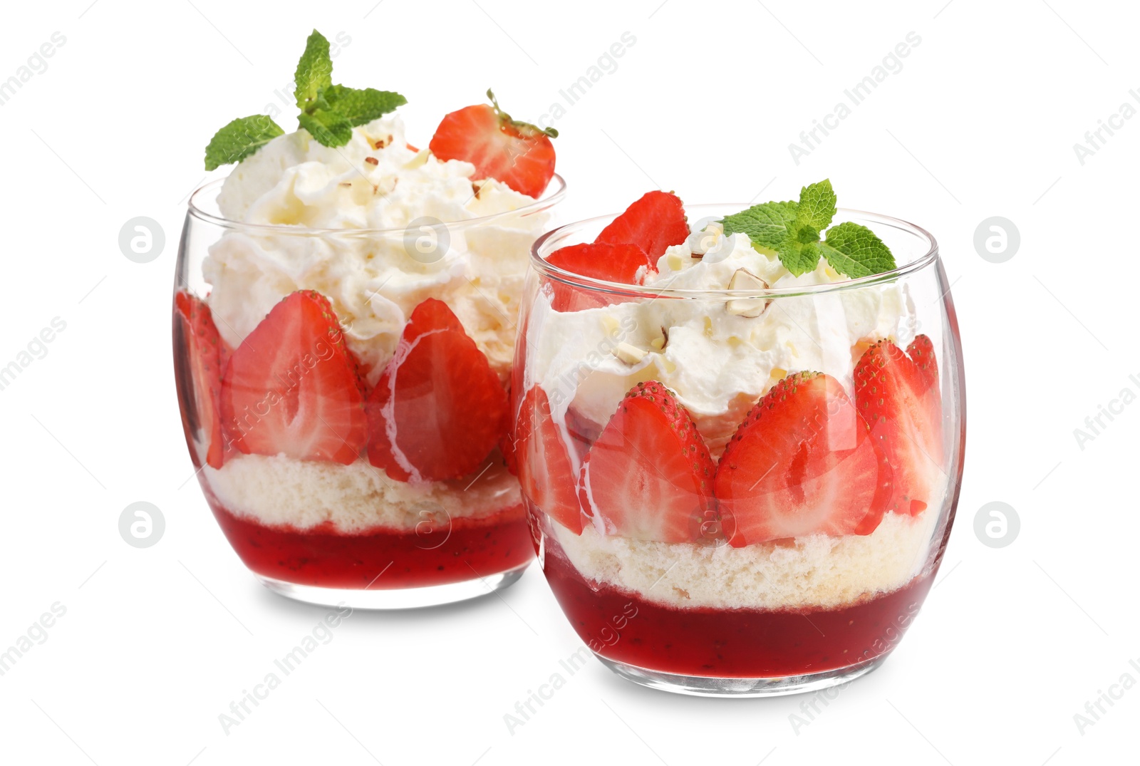 Photo of Tasty trifle dessert. Sponge cake, strawberries, jam and whipped cream in glasses isolated on white