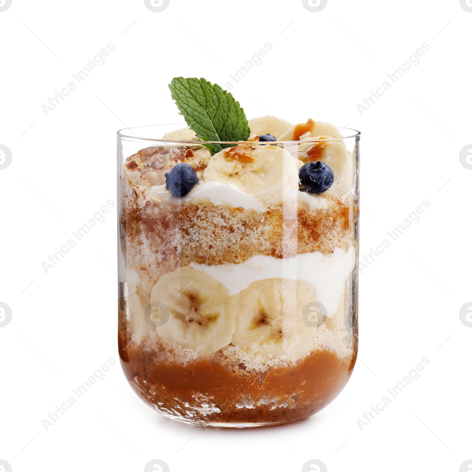 Photo of Tasty trifle dessert. Sponge cake, blueberries, banana and whipped cream in glass isolated on white