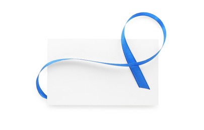 Photo of Blank card and blue ribbon isolated on white, top view