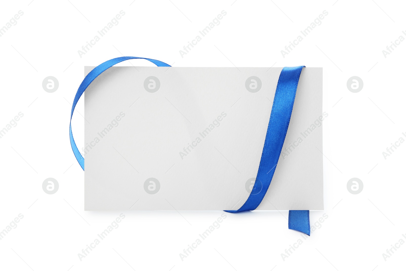 Photo of Blank card and blue ribbon isolated on white