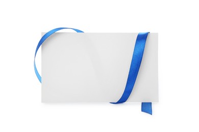 Photo of Blank card and blue ribbon isolated on white