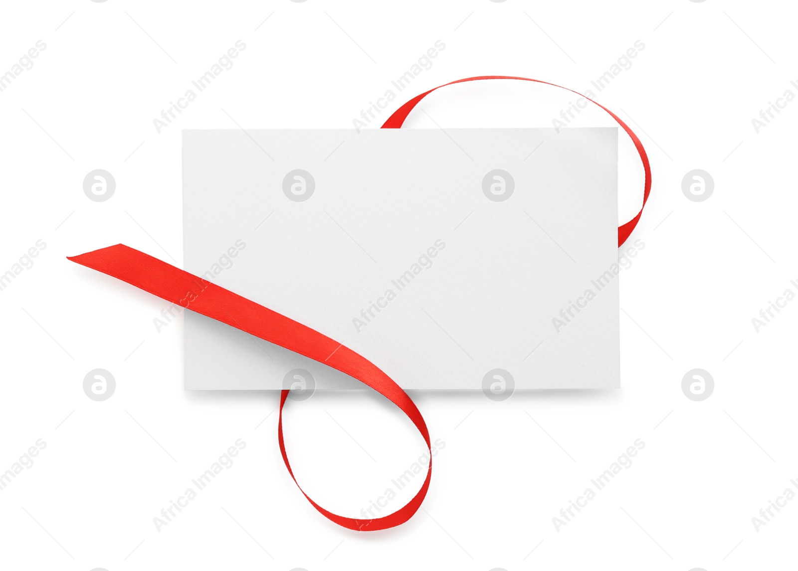 Photo of Blank card and red ribbon isolated on white, top view