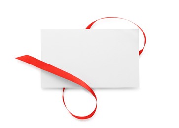 Photo of Blank card and red ribbon isolated on white, top view