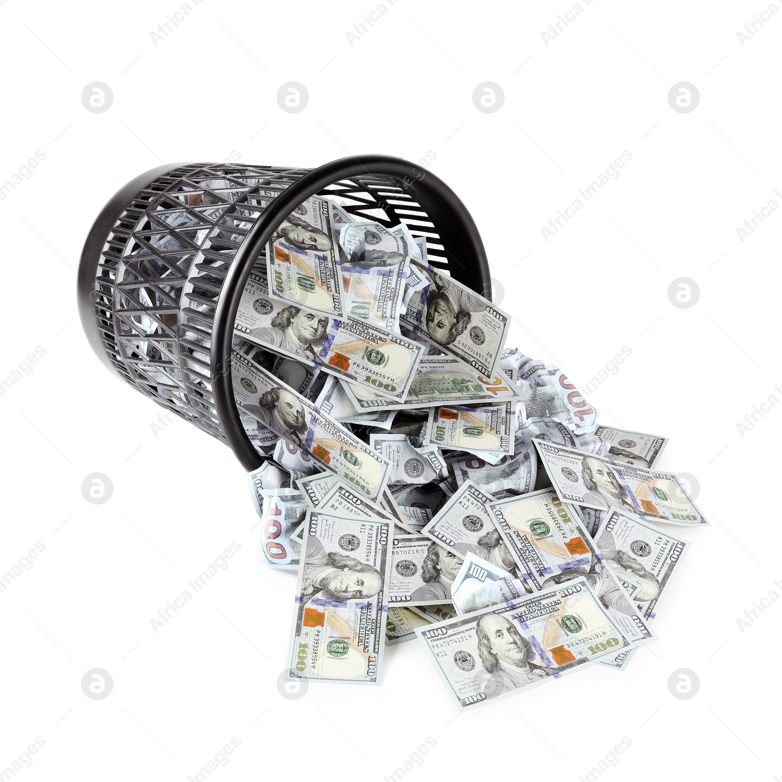 Photo of Many dollar banknotes and overturned trash bin isolated on white