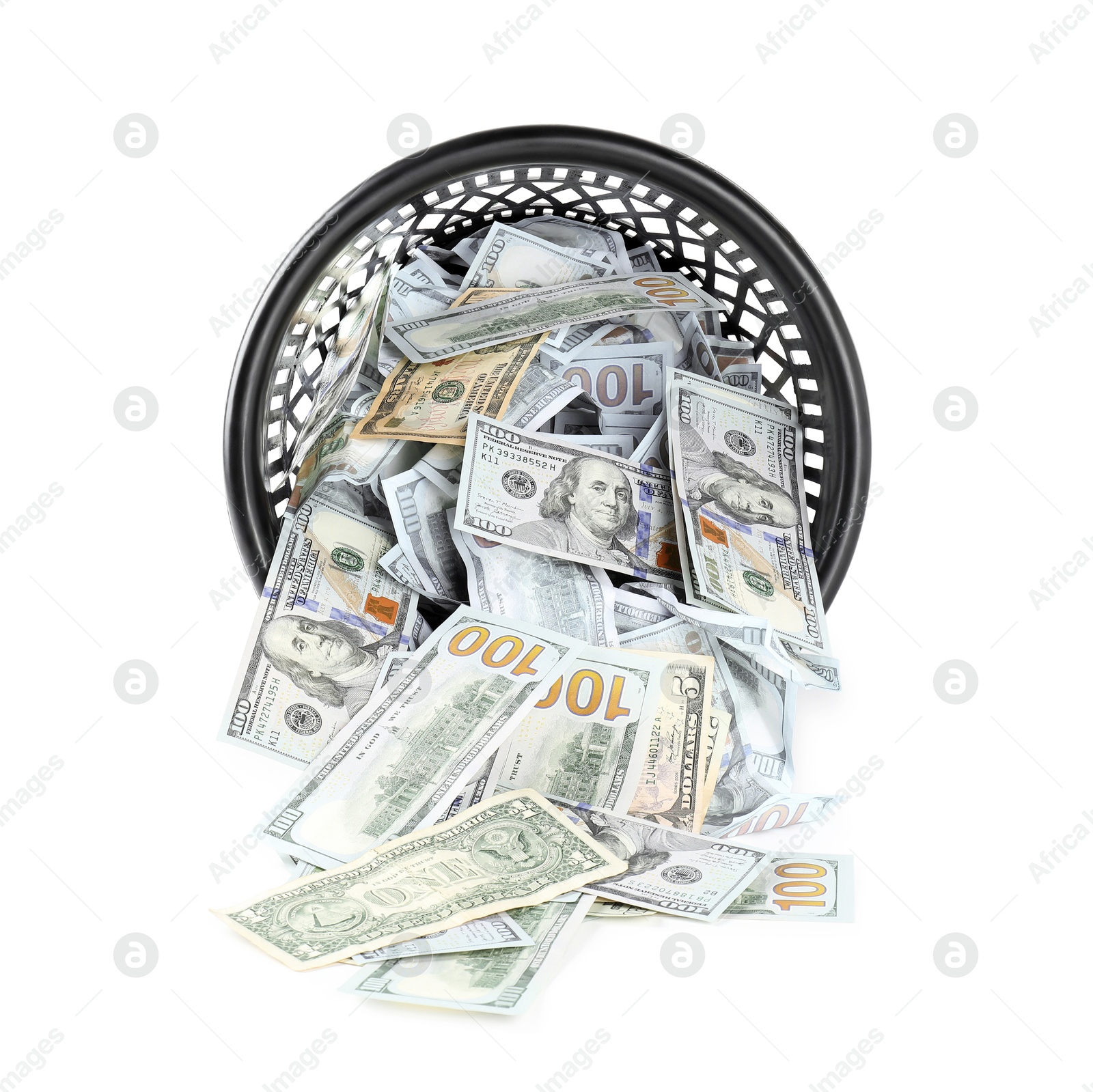 Photo of Many dollar banknotes and overturned trash bin isolated on white