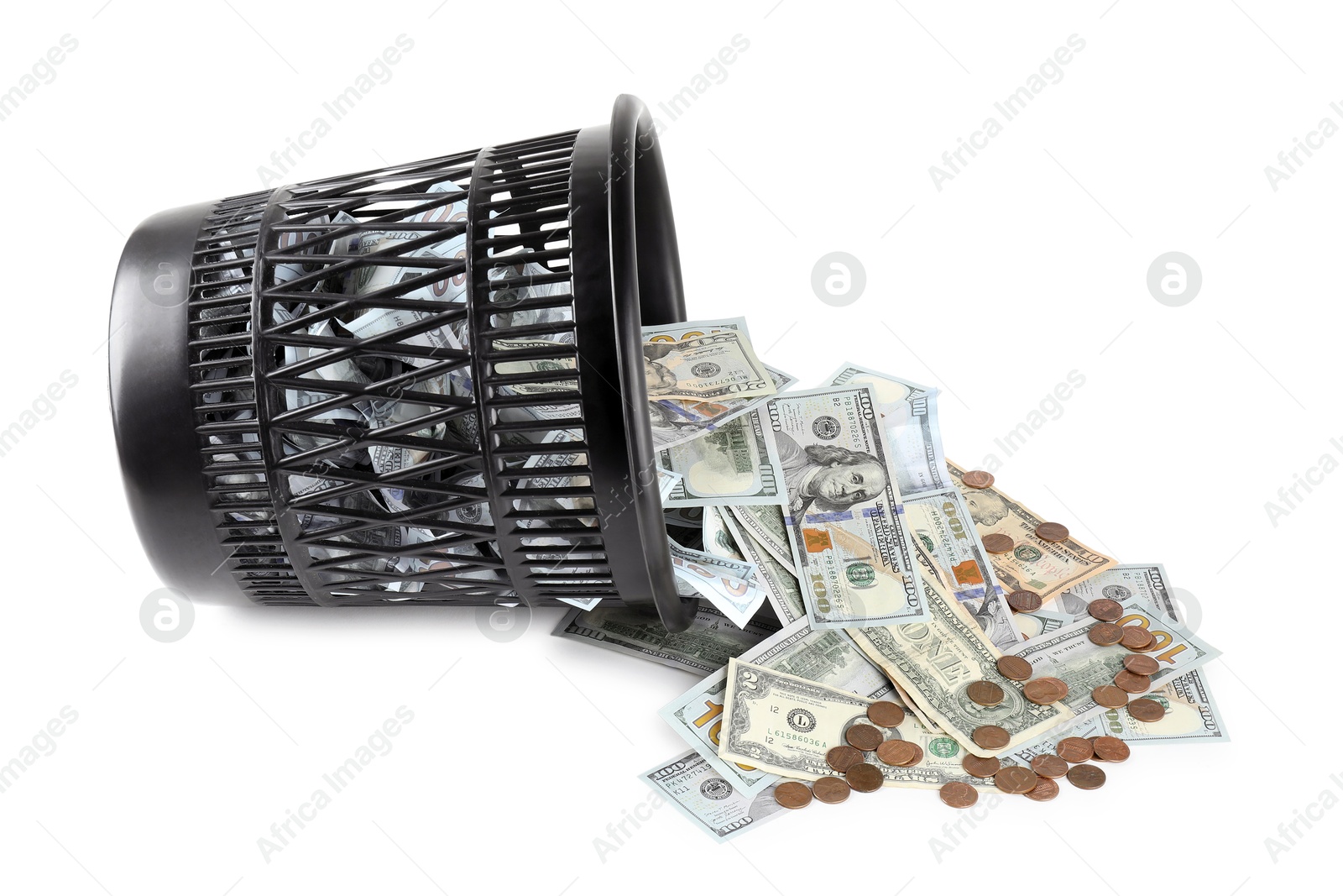 Photo of Many dollar banknotes, coins and overturned trash bin isolated on white