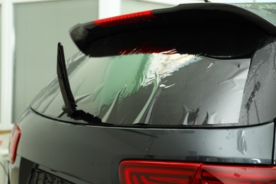 Photo of Car window covered with tinting foil, closeup