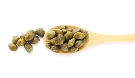 Photo of Wooden spoon and capers on white background, top view