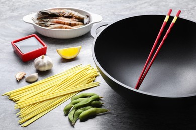 Different ingredients for wok on grey textured table