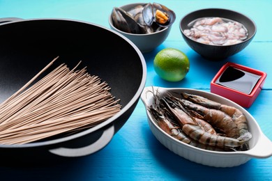 Photo of Different ingredients for wok on light blue wooden table