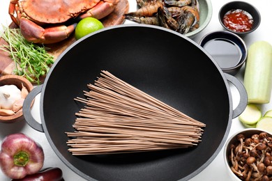 Photo of Different ingredients for wok on white table