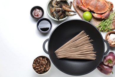 Different ingredients for wok on white table, flat lay