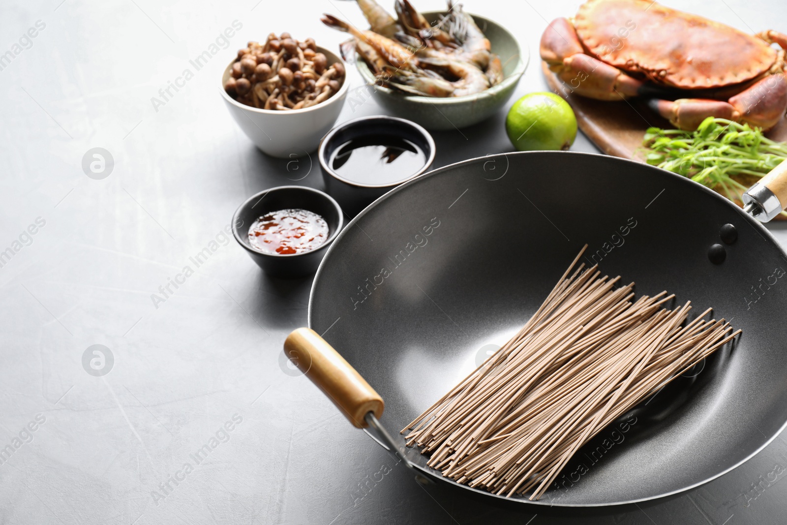 Photo of Different ingredients for wok on light grey table