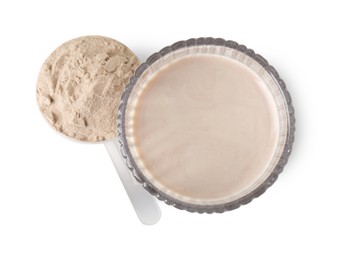 Photo of Delicious protein shake in glass and scoop with powder isolated on white, top view