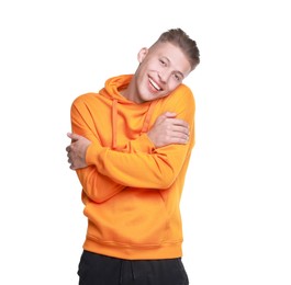 Photo of Young man hugging himself on white background