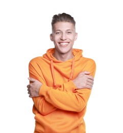 Young man hugging himself on white background