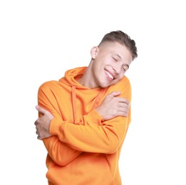 Young man hugging himself on white background