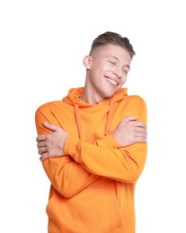 Young man hugging himself on white background