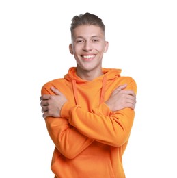 Young man hugging himself on white background