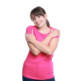 Young woman hugging himself on white background