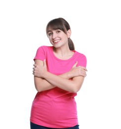 Young woman hugging himself on white background