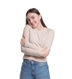 Photo of Charming young woman hugging herself on white background