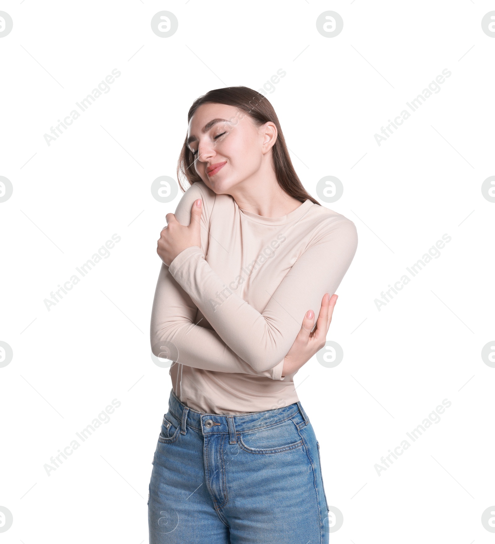 Photo of Charming young woman hugging herself on white background