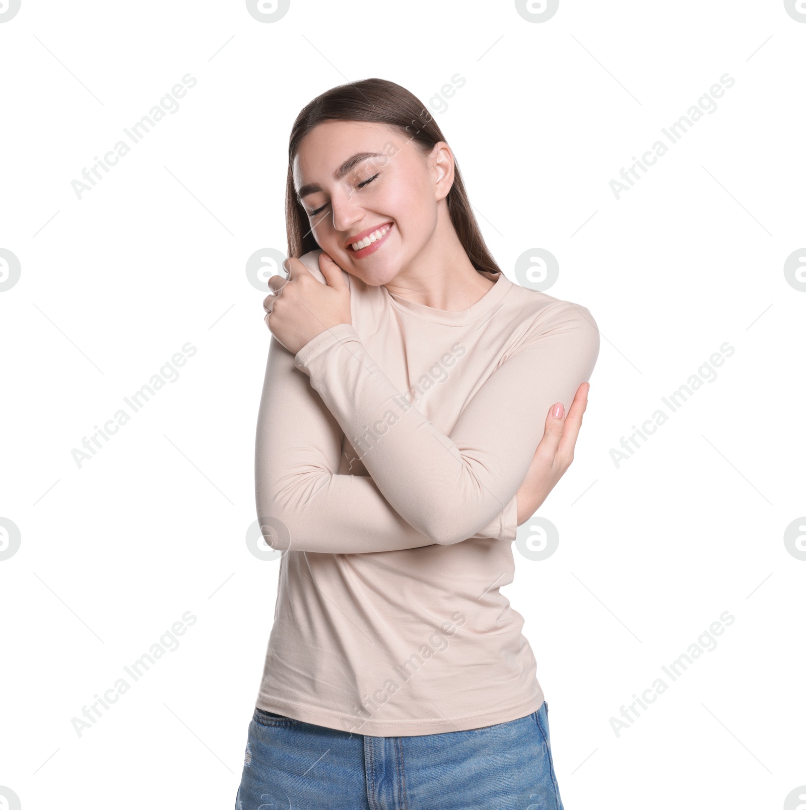 Photo of Charming young woman hugging herself on white background