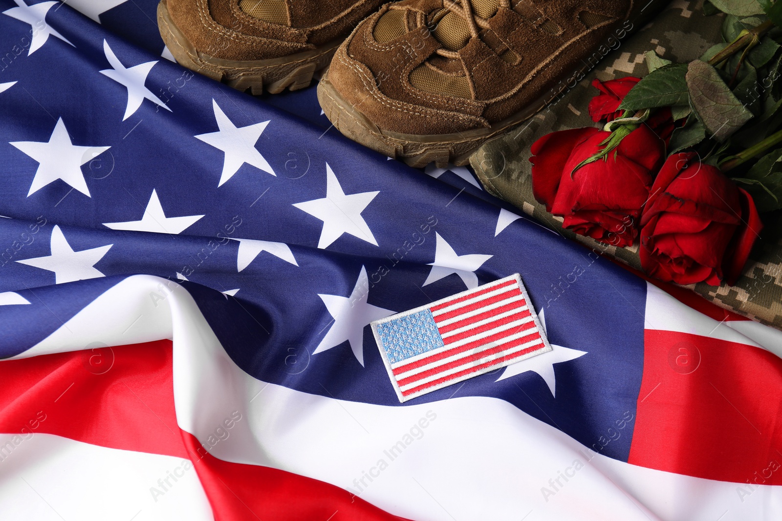 Photo of Veterans day. USA army patch, American flag, roses and military uniform, flat lay