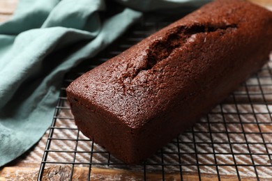 Photo of Tasty chocolate sponge cake on wooden table, closeup