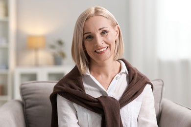 Photo of Portrait of smiling middle aged woman at home