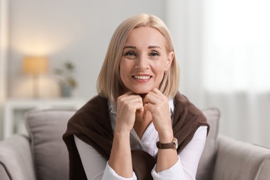 Photo of Portrait of smiling middle aged woman at home