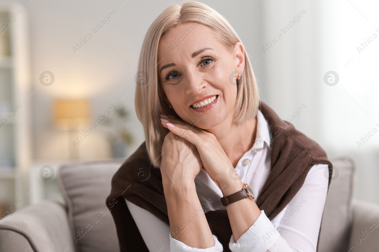 Photo of Portrait of smiling middle aged woman at home