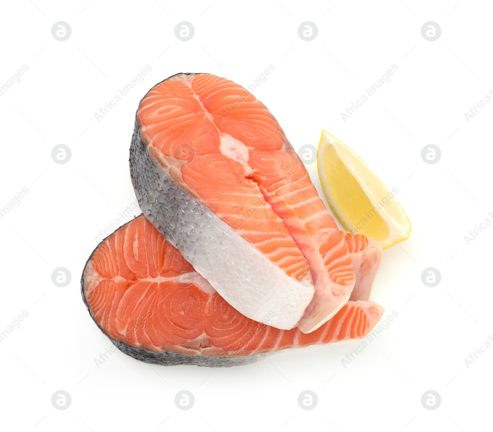 Photo of Steaks of fresh raw salmon and lemon isolated on white