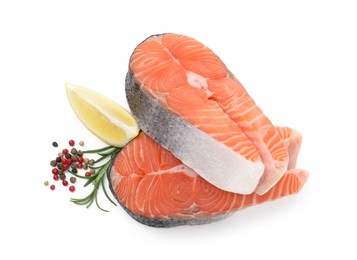 Photo of Fresh raw salmon steaks and spices isolated on white